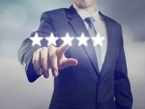 Man in a suit touching a floating star rating